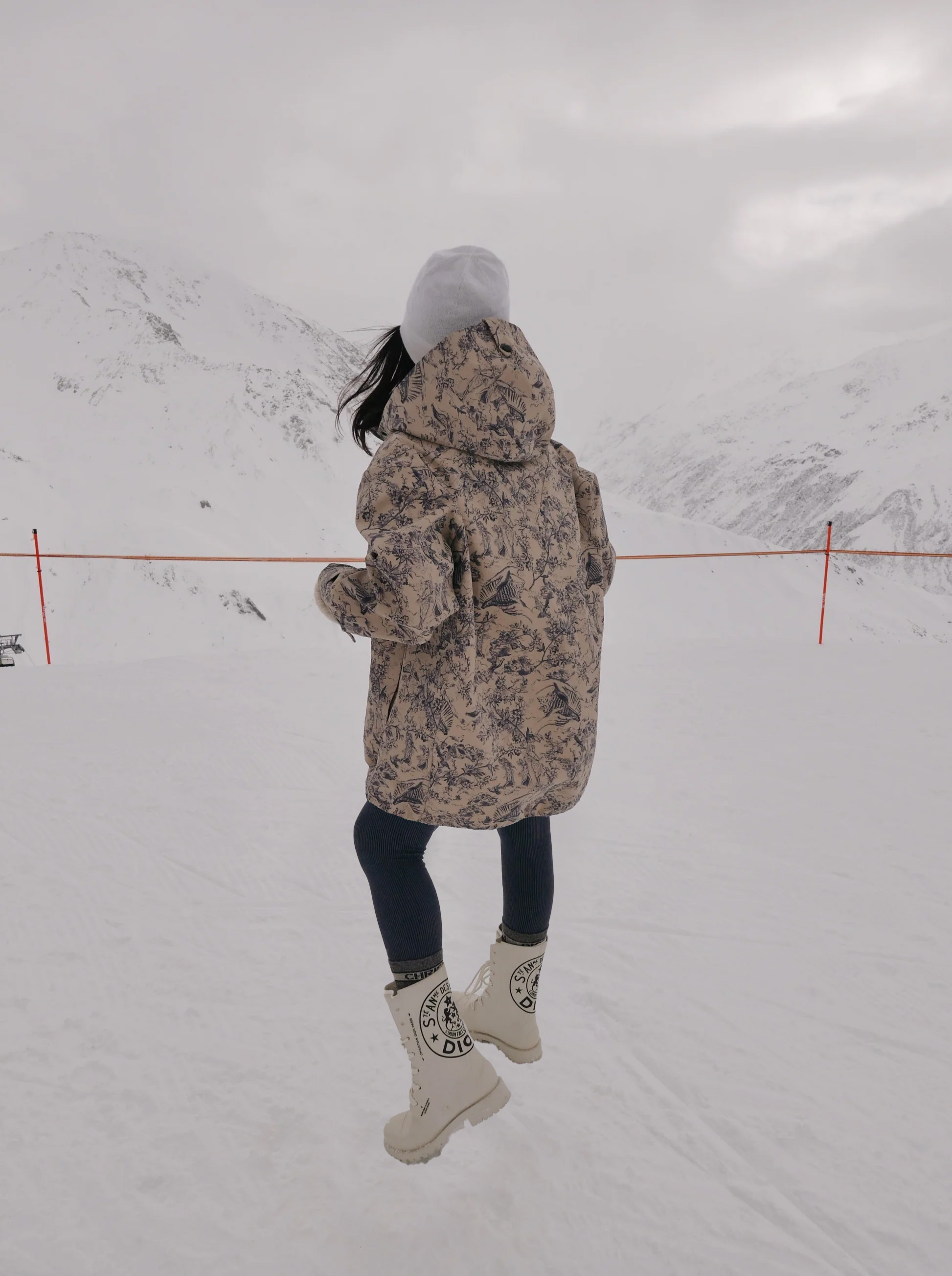 Short woman wearing black leggins and anorak jacket in winter